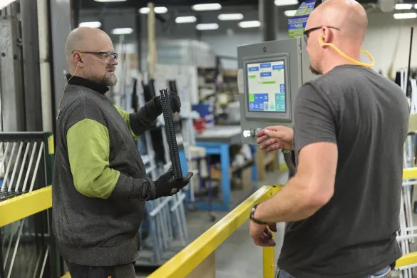 people talking to each other in a factory